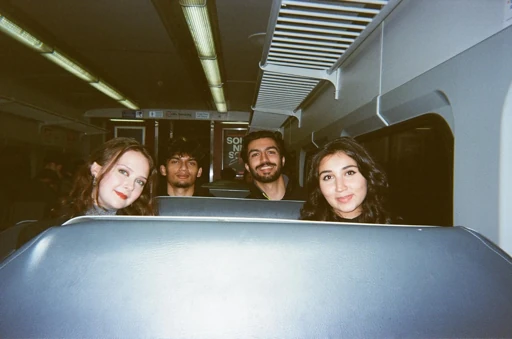 Friends sitting behind a sculptural installation