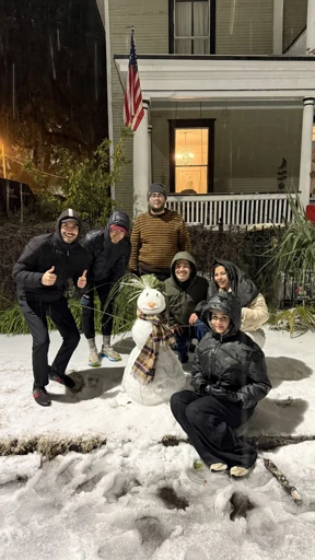 Friends outside on a snowy evening