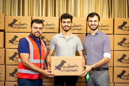 Volunteers holding a food donation box