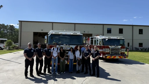 Group portrait beside fire engines