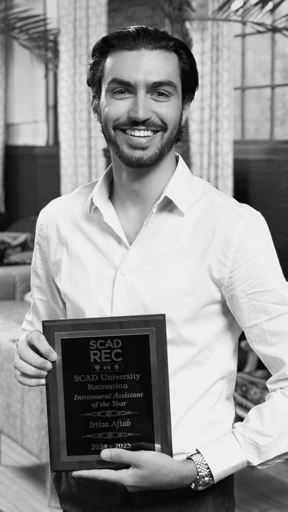 Black and white portrait holding an award