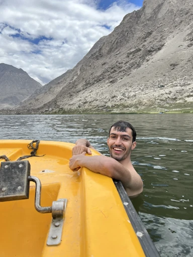 Swimming beside a boat in a mountain lake